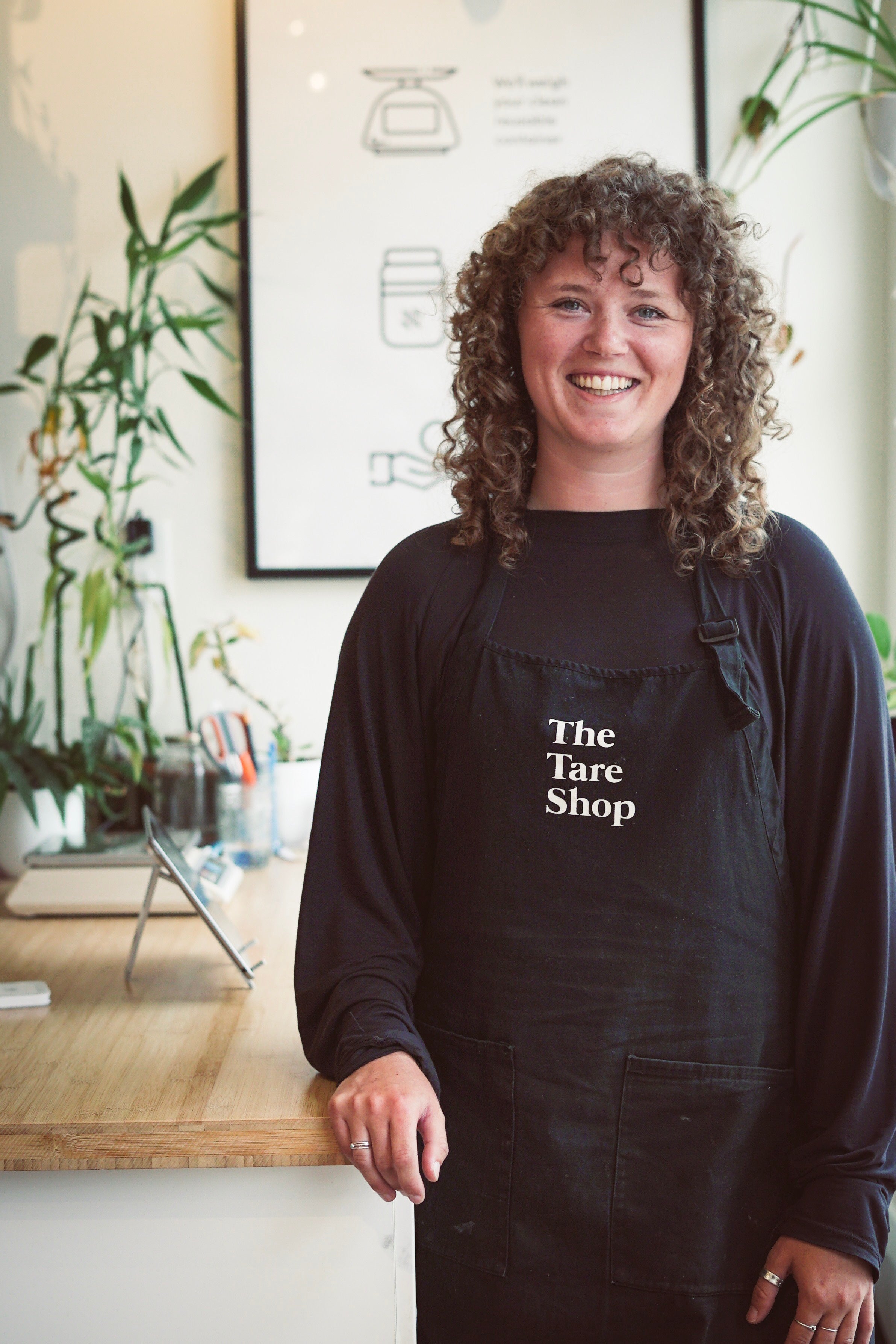 Kate Pepler smiling to the camera wearing a Tare Shop apron.