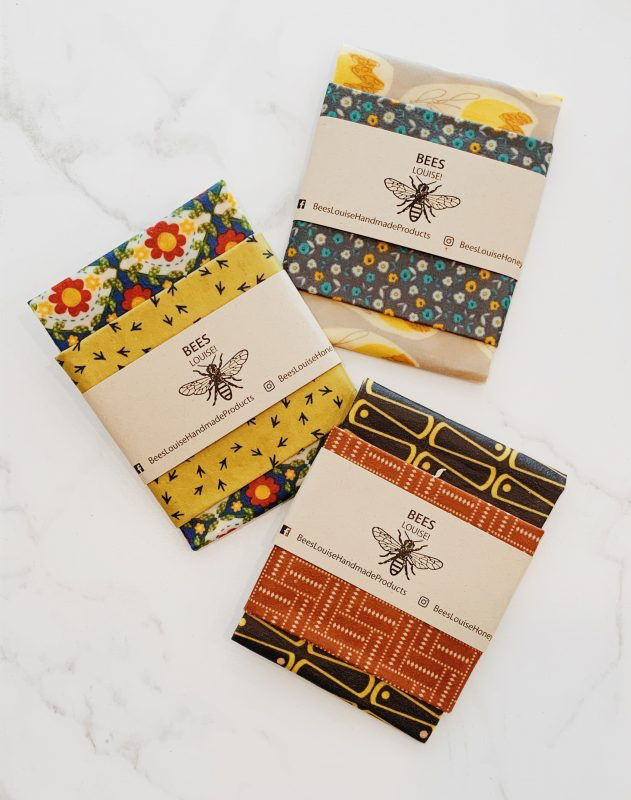 Three beeswax wraps by Bees Louise sit on a table.
